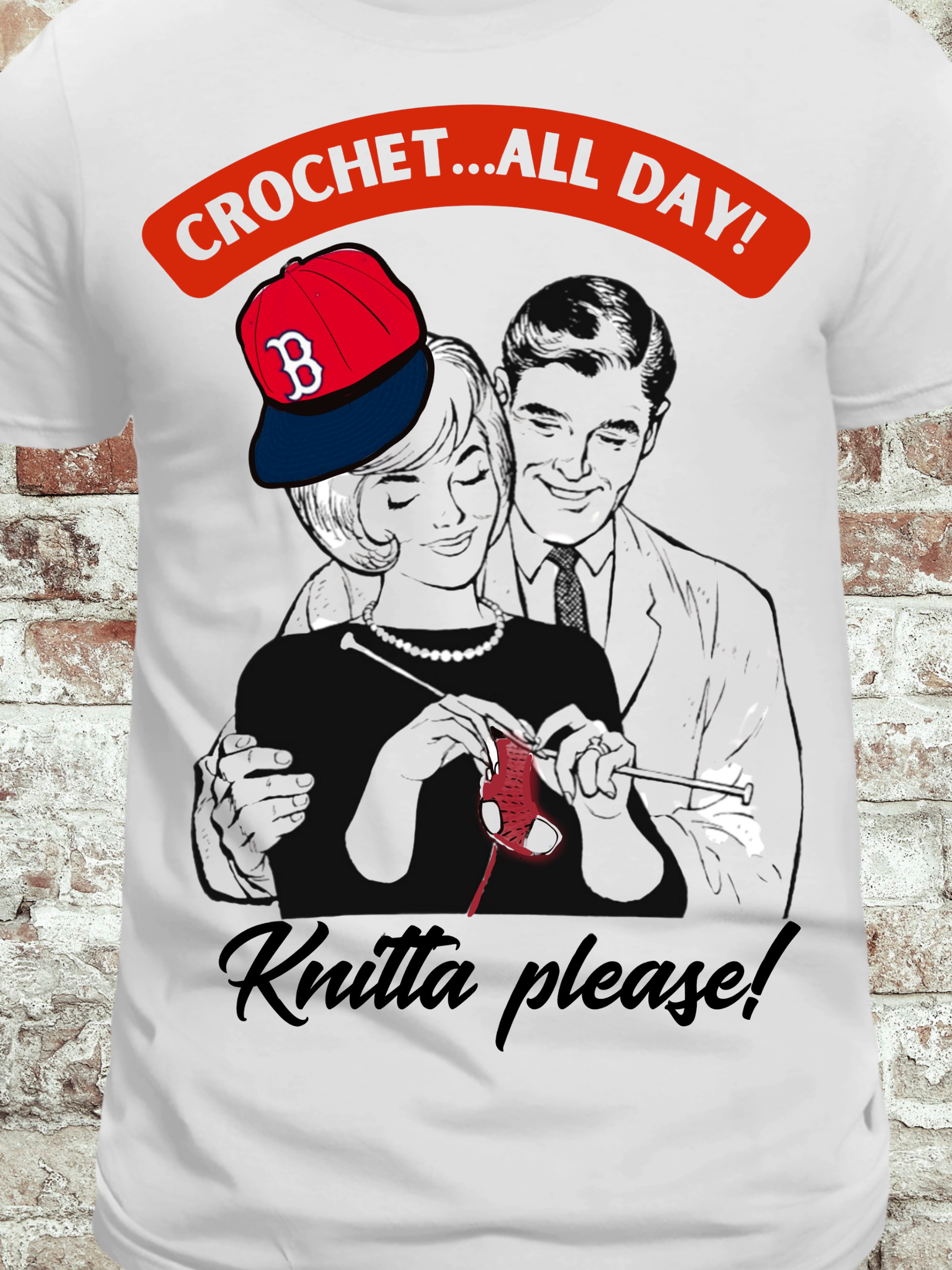 White t-shirt featuring a vintage-style couple, with the woman crocheting red yarn and the phrase 'Crochet...All Day! Knitta please!' in bold text