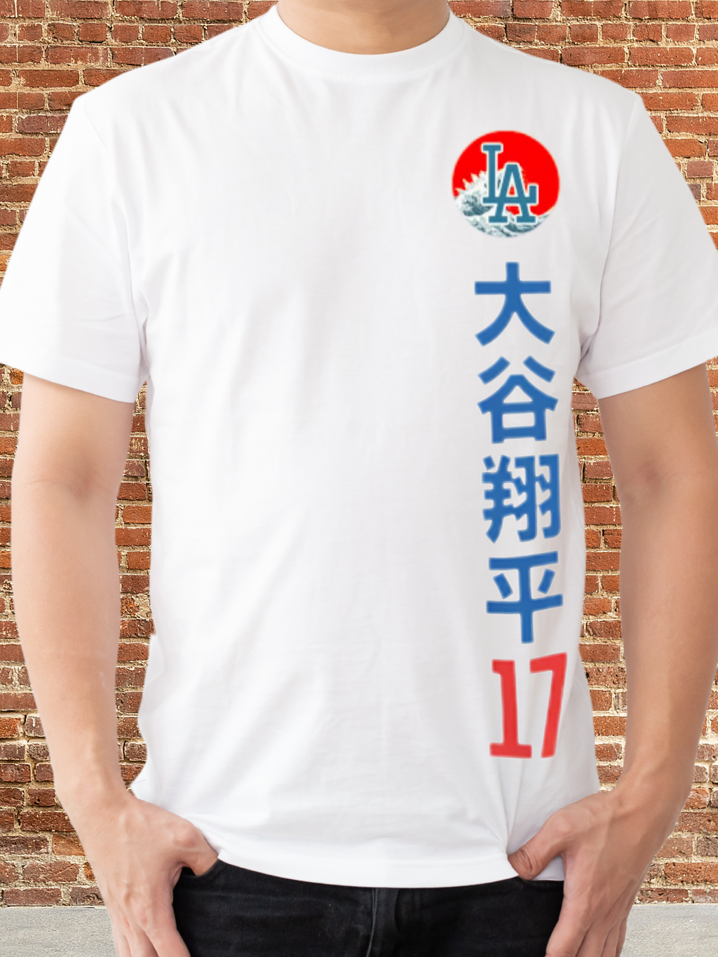 Graphic t-shirt with a split-face design featuring a blue samurai mask and a baseball player in a white and blue uniform, set against a red circle with Japanese characters above — representing dual power and cultural fusion